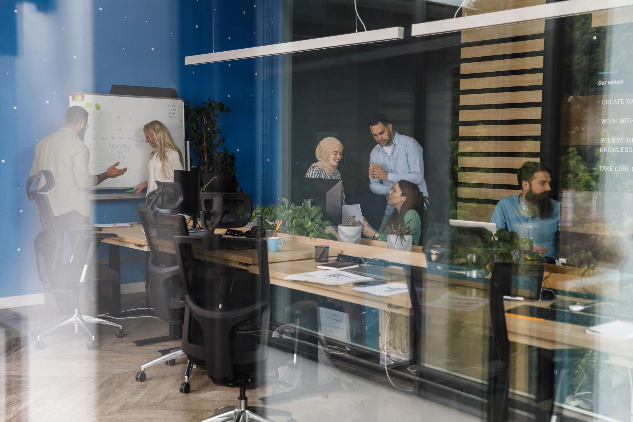 IT professionals collaborating in an office meeting space